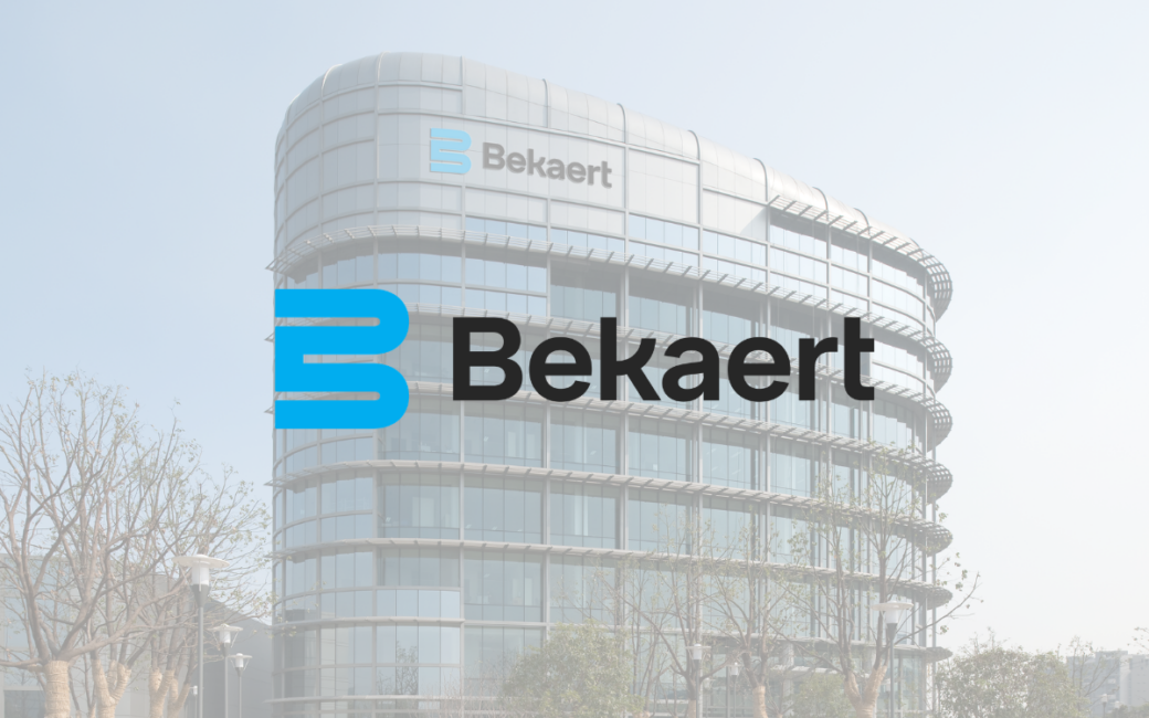 Modern glass building with trees in front, featuring "Bekaert" logo prominently displayed.